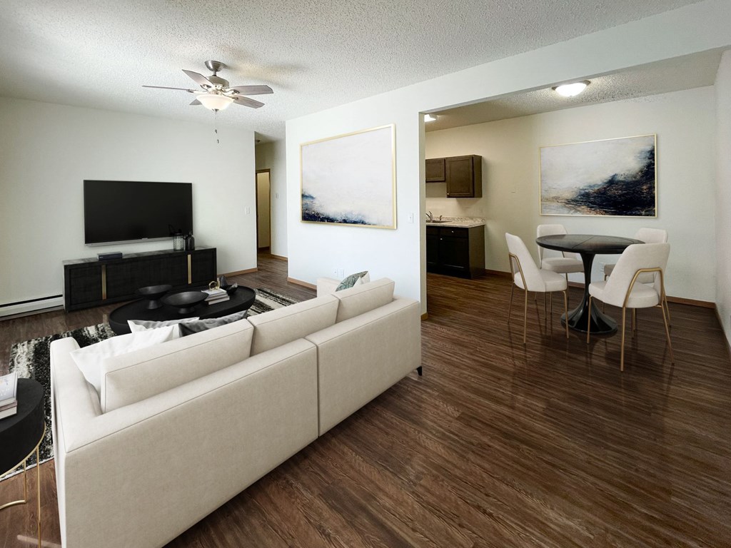 Bismarck, ND Belmont West Apartments | 11A | Living A living room with a white couch and a television. Bismarck, ND Belmont West Apartments