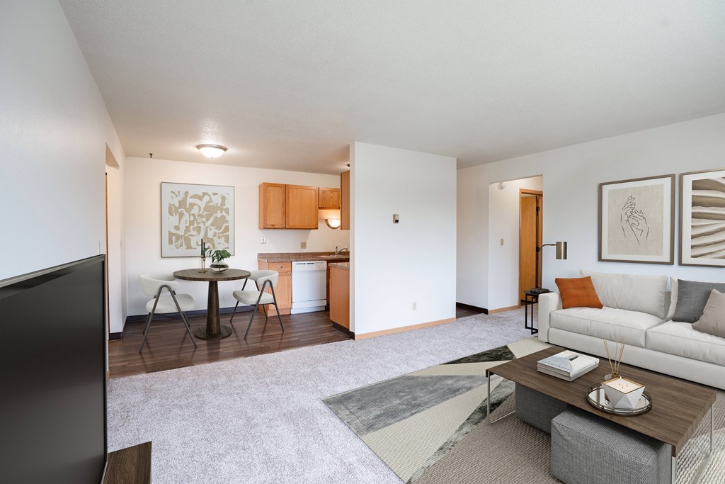 West Fargo, ND Saddlebrook Apartments | 21B | Living A living room with a couch, coffee table, and television. West Fargo, ND Saddlebrook Apartments