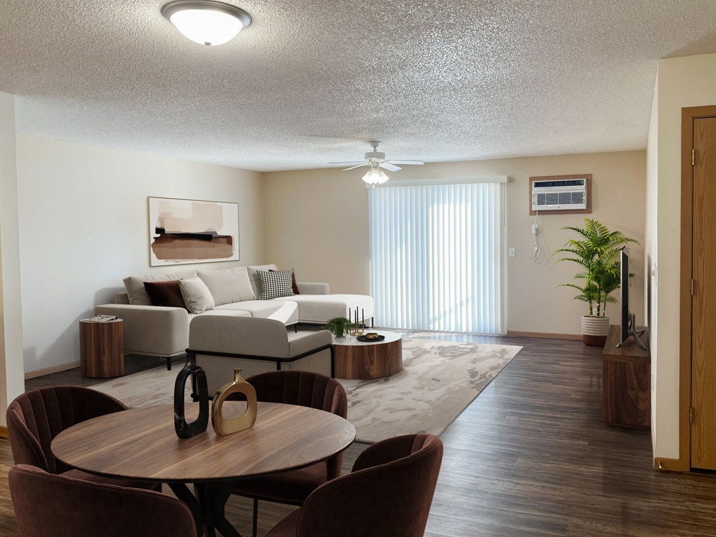 A living room with a brown table and chairs. Bismarck, ND Sierra Ridge Apartments