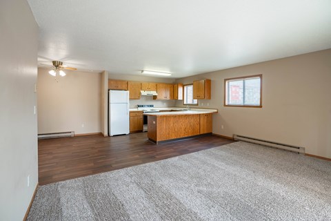 A kitchen with wooden cabinets and a white refrigerator.