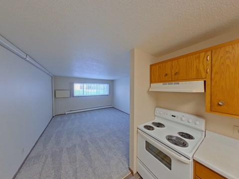 A small room with a stove and a window.
