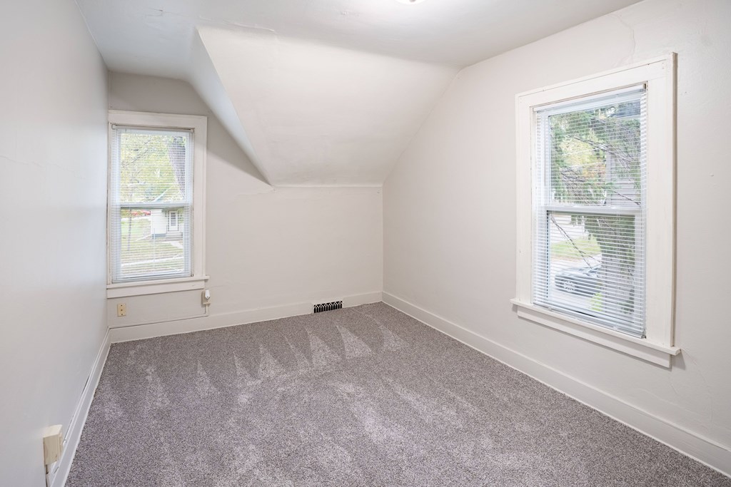 A room with a window and a carpet on the floor. Fargo, ND Marlowe South Apartments