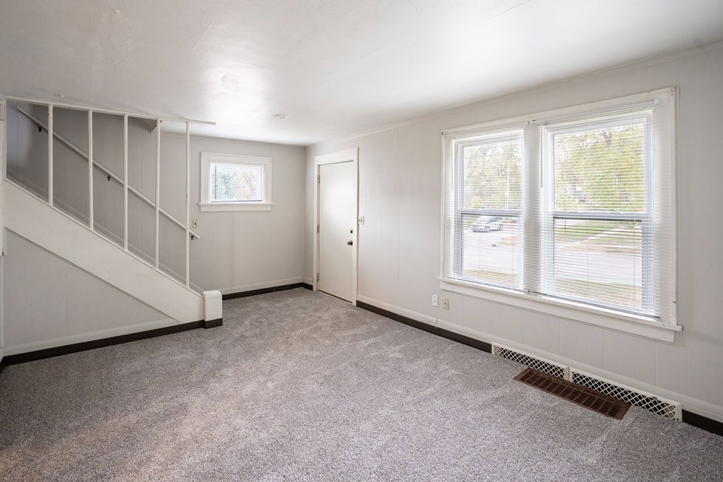 A room with a staircase and a window. Fargo, ND Marlowe South Apartments