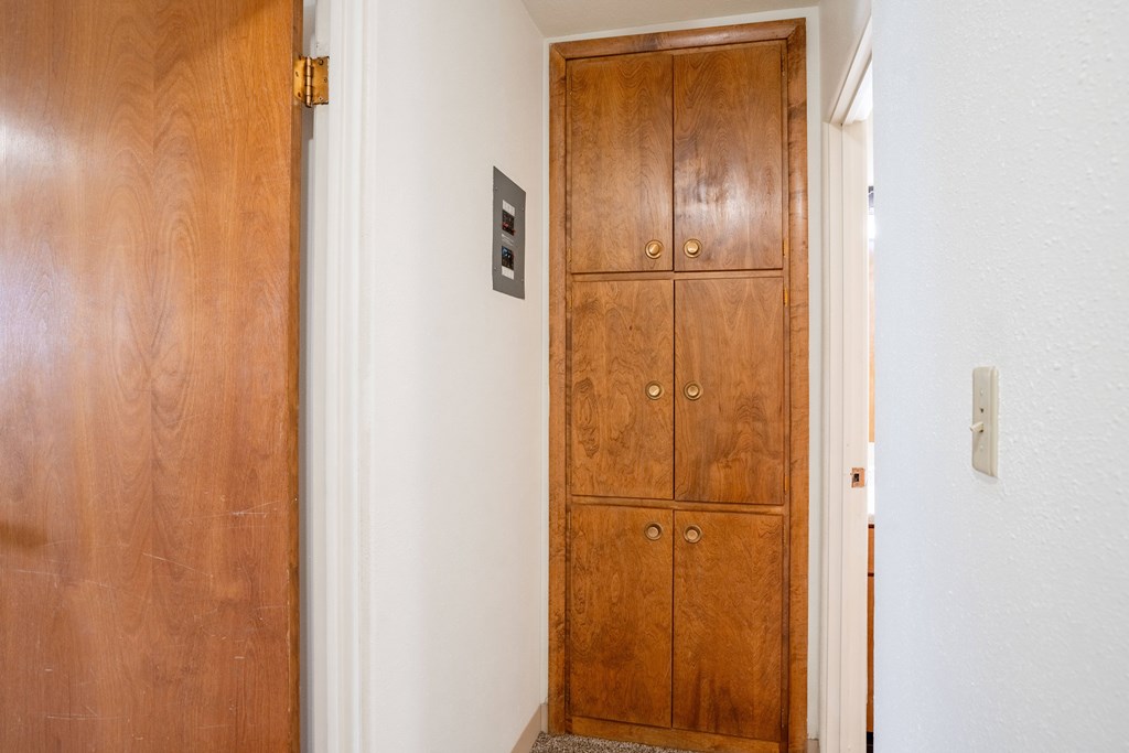 A brown wooden door with a handle and a lock. Fargo, ND Islander Apartments