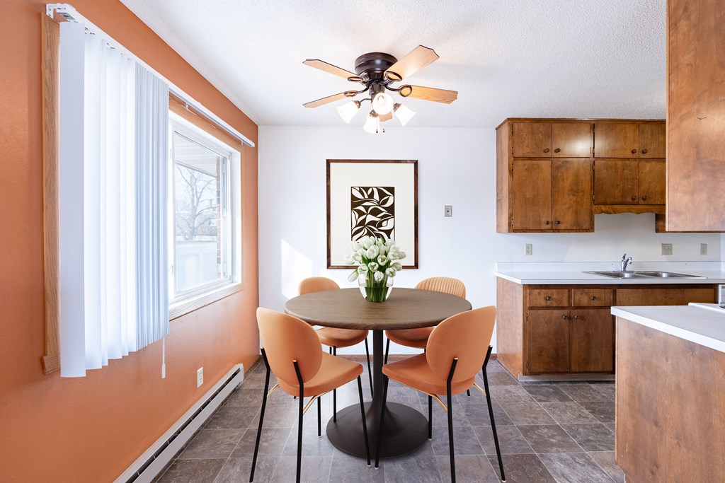 A dining room with a table and chairs. Fargo, ND Carr Apartments