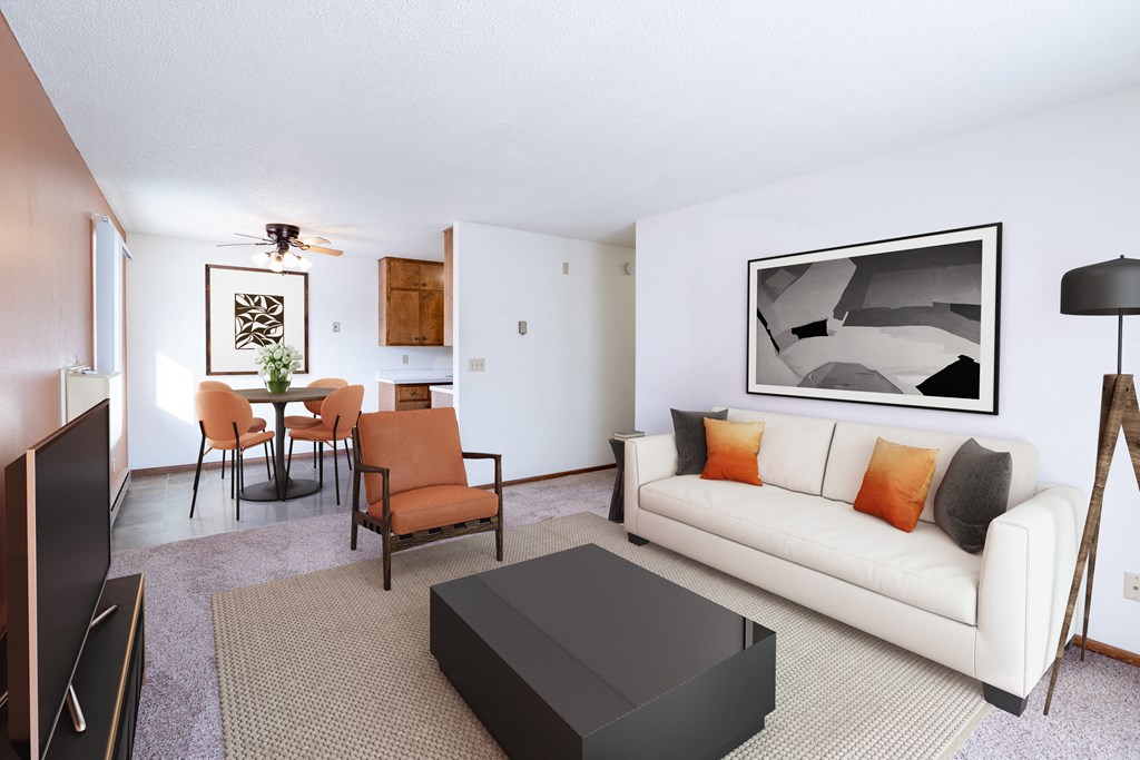 A living room with a white couch and a black coffee table.  Fargo, ND Carr Apartments