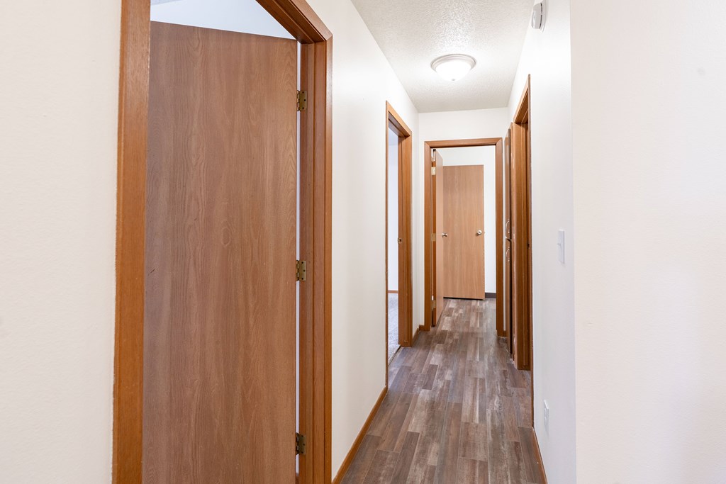 A long hallway with wooden doors on both sides. Fargo, ND Westwood Estates