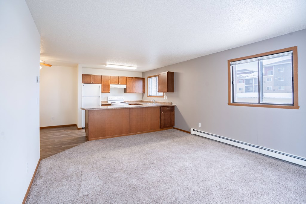 A kitchen area with a counter and a window. Fargo, ND Westwood Estates