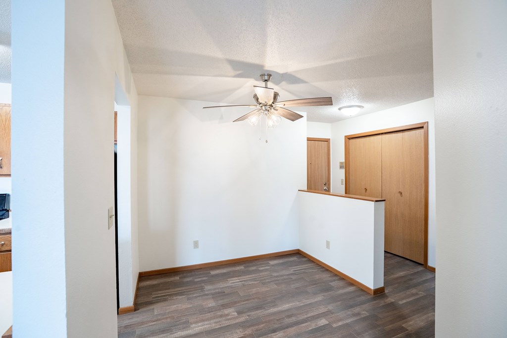 A room with a ceiling fan and a white wall. Fargo, ND Westwood Estates