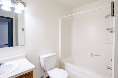 A white toilet sits next to a sink in a small bathroom.
