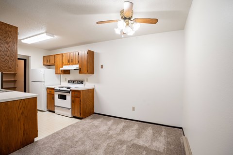 A kitchen with wooden cabinets and a white oven.