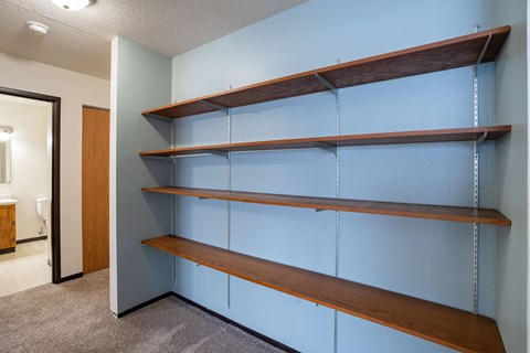 A wall of shelves in a room.