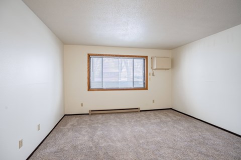 A room with a window and a bench.