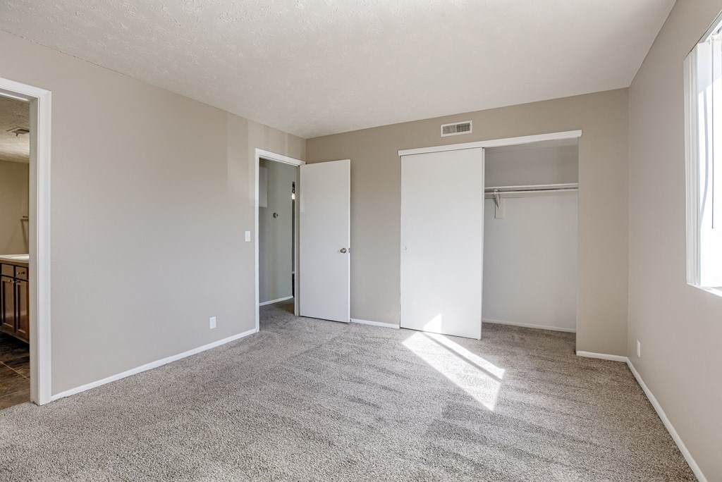 A room with carpeted floor and white walls. Omaha, NE Evergreen Terrace Apartments
