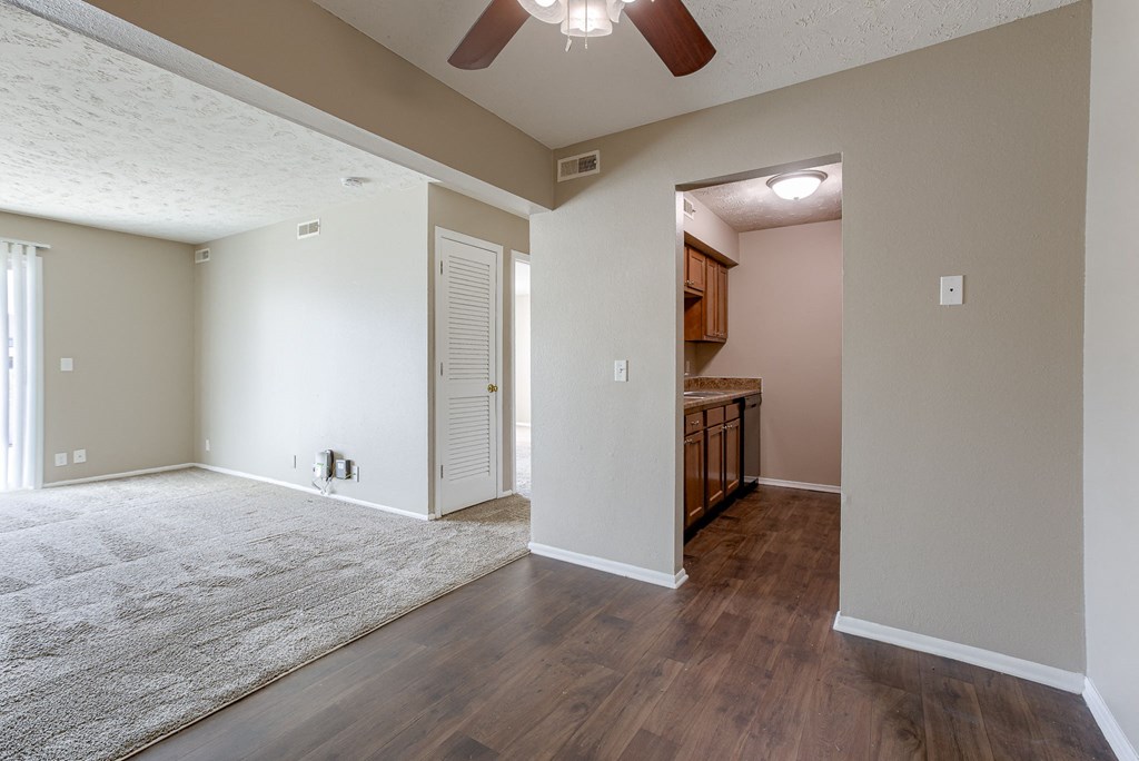 A room with a ceiling fan and wooden floors. Omaha, NE Evergreen Terrace Apartments