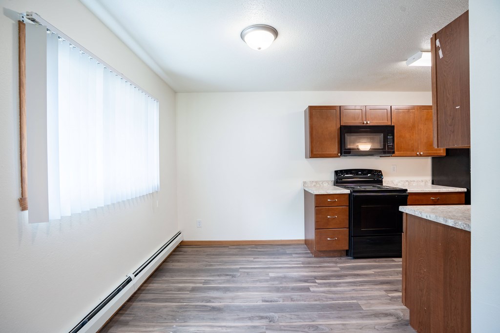 A kitchen with a black oven and microwave. Grand Forks, ND Columbia West Apartments