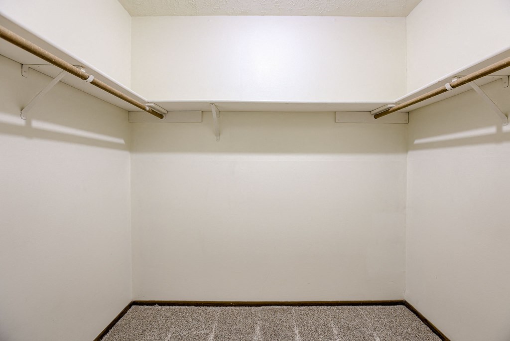 A small, empty room with a carpeted floor and two shelves. Omaha, NE Stony Brook Apartments