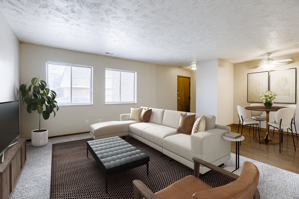 A living room with a white couch and a black coffee table. Omaha, NE Stony Brook Apartments