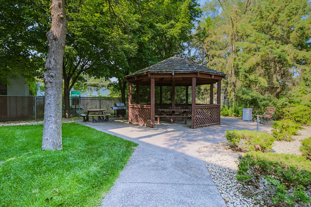Anoka, MN Dellwood Estates Apartments. a gazebo in a park with trees