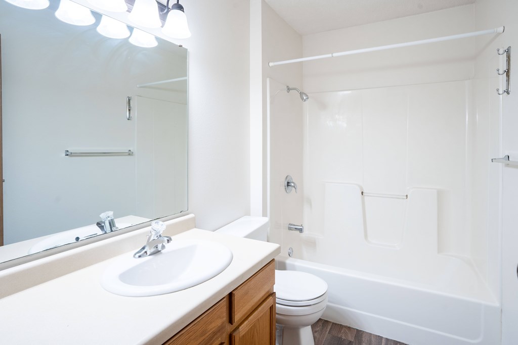 A white bathroom with a sink, toilet, and bathtub. Fargo, ND Hazelwood Townhomes