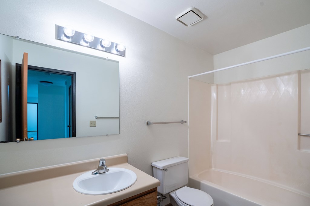 A bathroom with a sink, toilet, and bathtub. Grand Forks, ND Columbia West Apartments