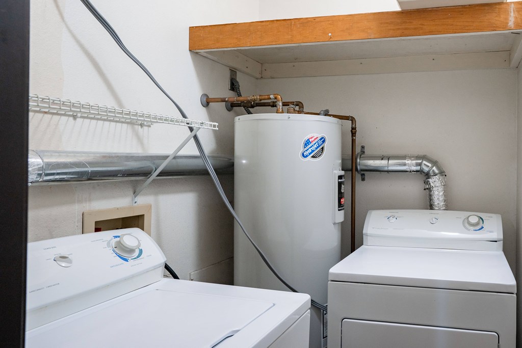 A small laundry room with a washer and dryer. Grand Forks, ND Columbia West Apartments