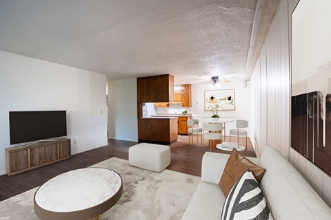 A modern living room with a white couch and a television.