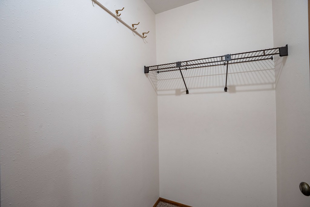 A white wall with a black metal rack on it. West Fargo, ND Clearview Apartments