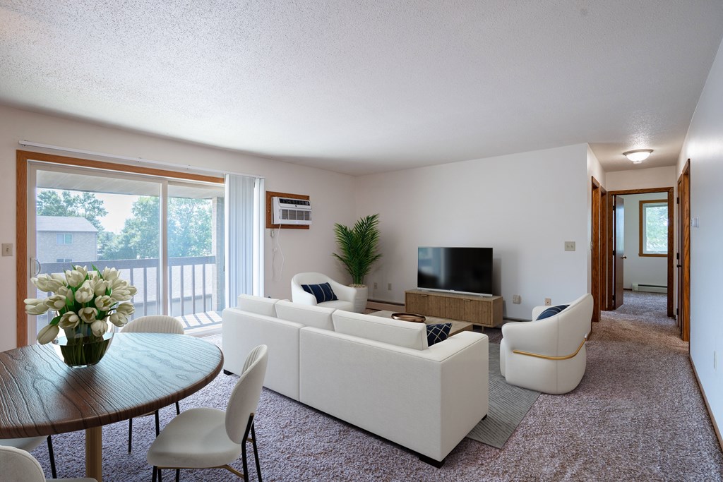 A living room with a white couch and a television. West Fargo, ND Clearview Apartments