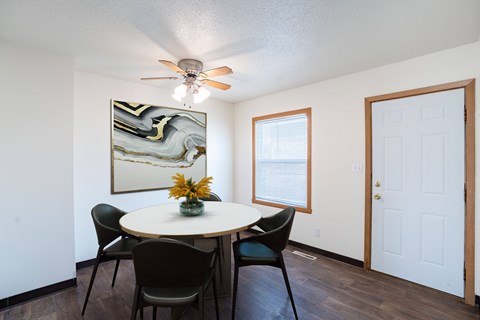 A dining room with a round table and chairs. West Fargo, ND Sheyenne Terrace Townhomes