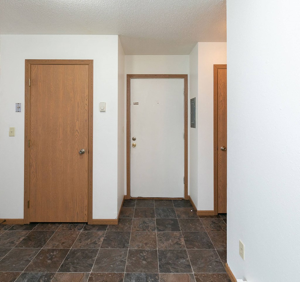 an entry door with a closet. Fargo, ND White Ridge Apartments