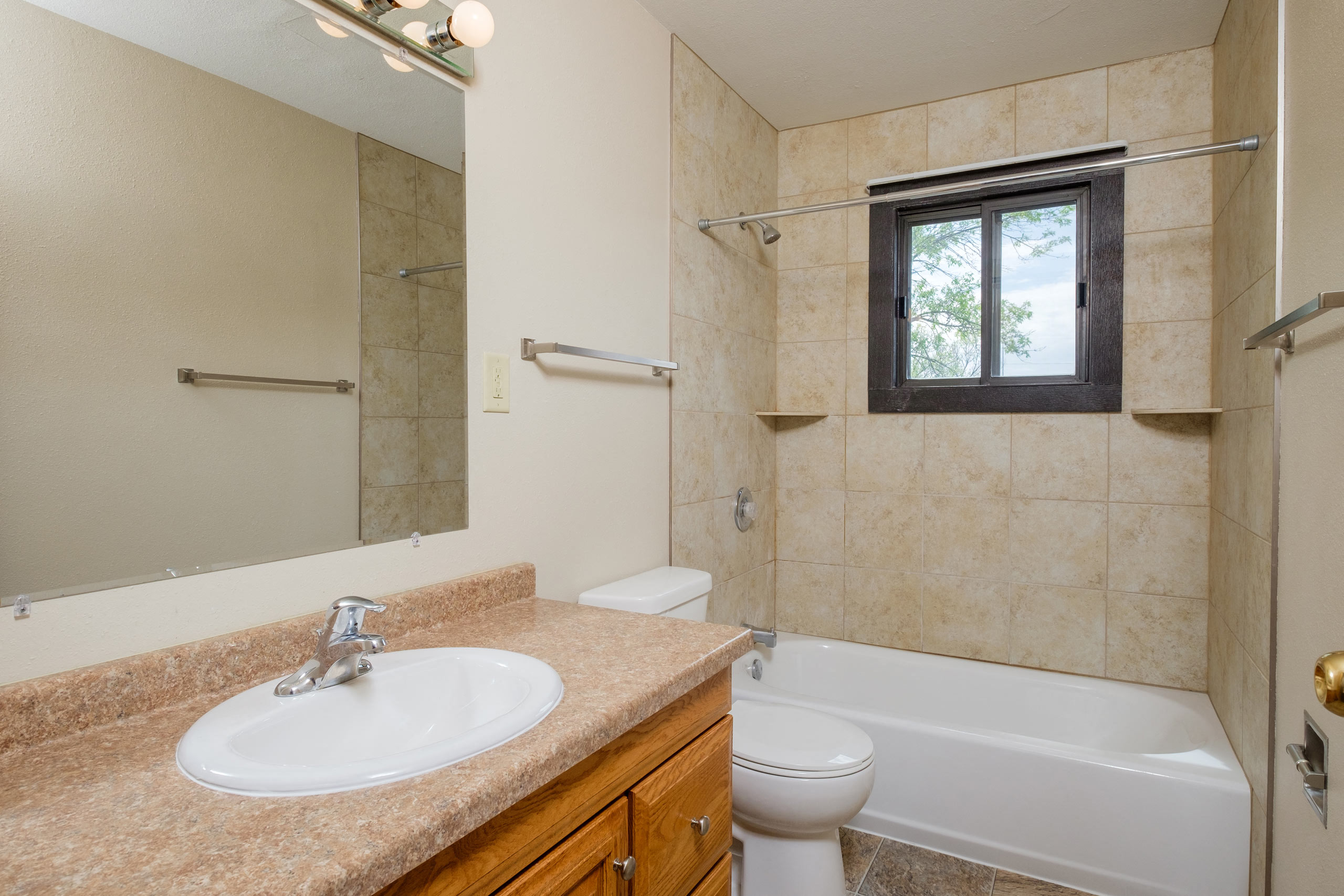 a bathroom with a sink and a toilet and a shower. Fargo, ND Birchwood 2 Apartments