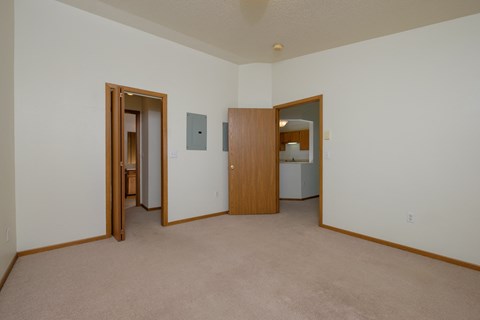 a master bedroom with a closet leading to a bathroom. Fargo, ND Bridgeport Apartments