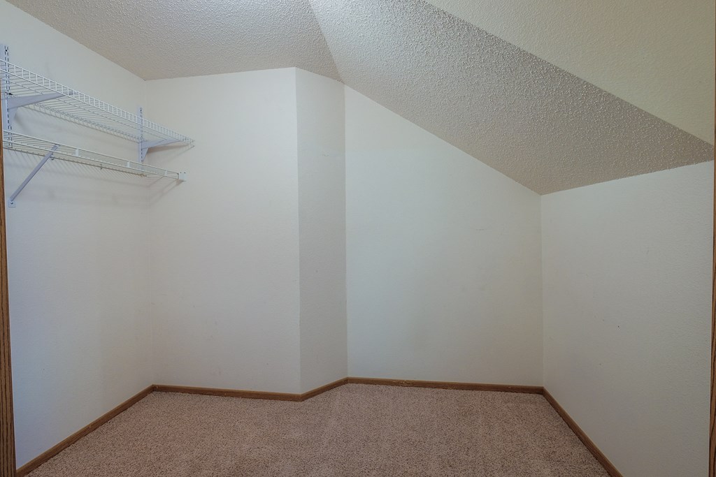 a closet with a shelf. Fargo, ND Bridgeport Apartments