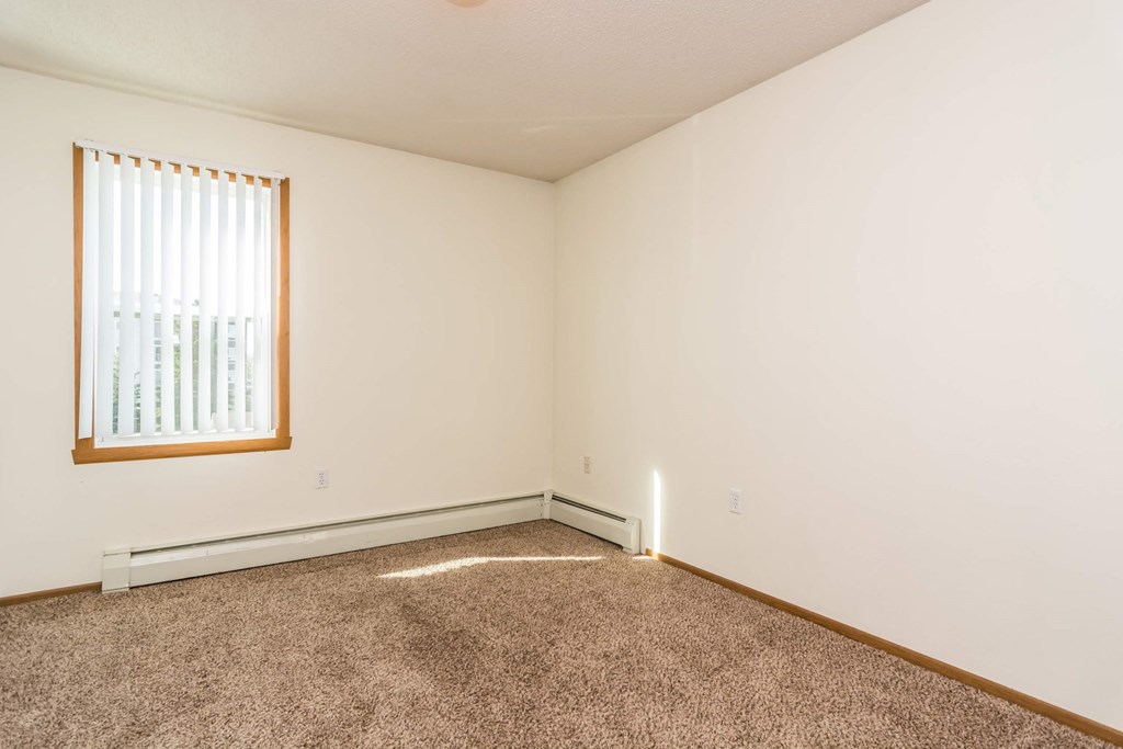 Grand Forks, ND Bristol Park Apartments. a bedroom with white walls and a window