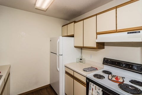 Grand Forks, ND Bristol Park Apartments. a kitchen with white cabinets and a white stove top oven