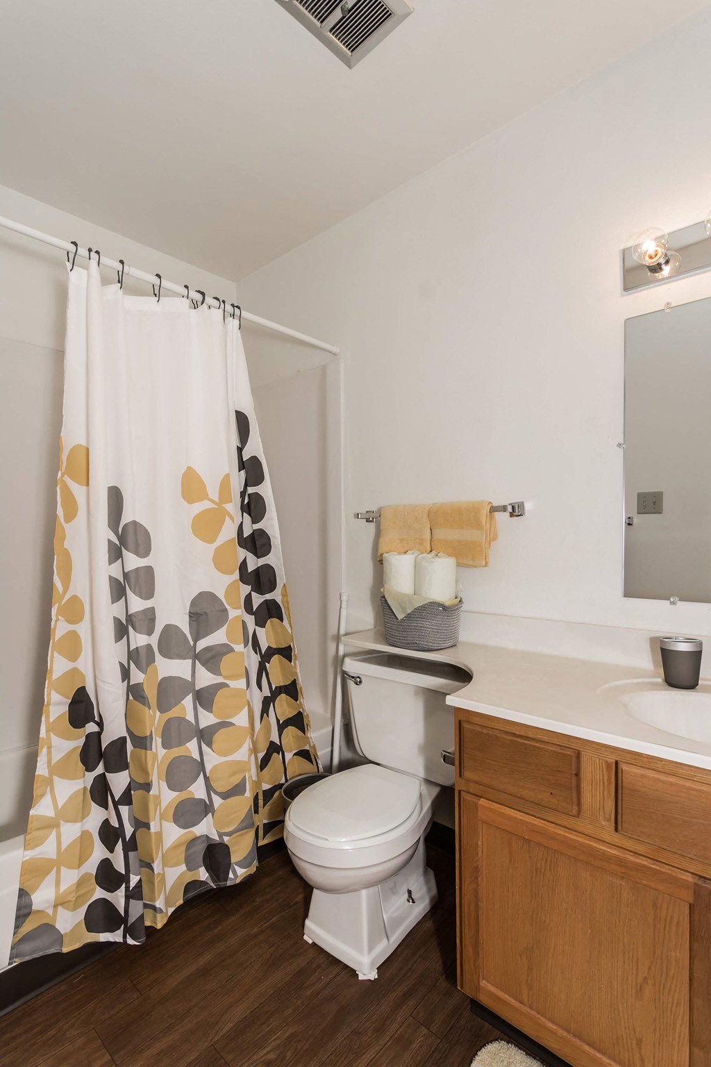 Grand Forks, ND Bristol Park Apartments. a bathroom with a white sink and toilet next to a shower curtain