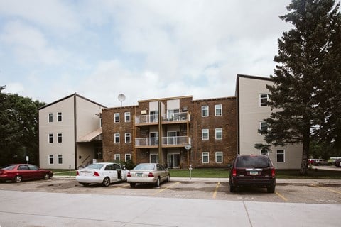 Grand Forks, ND Bristol Park Apartments.  A brick apartment building with cars parked in front of it