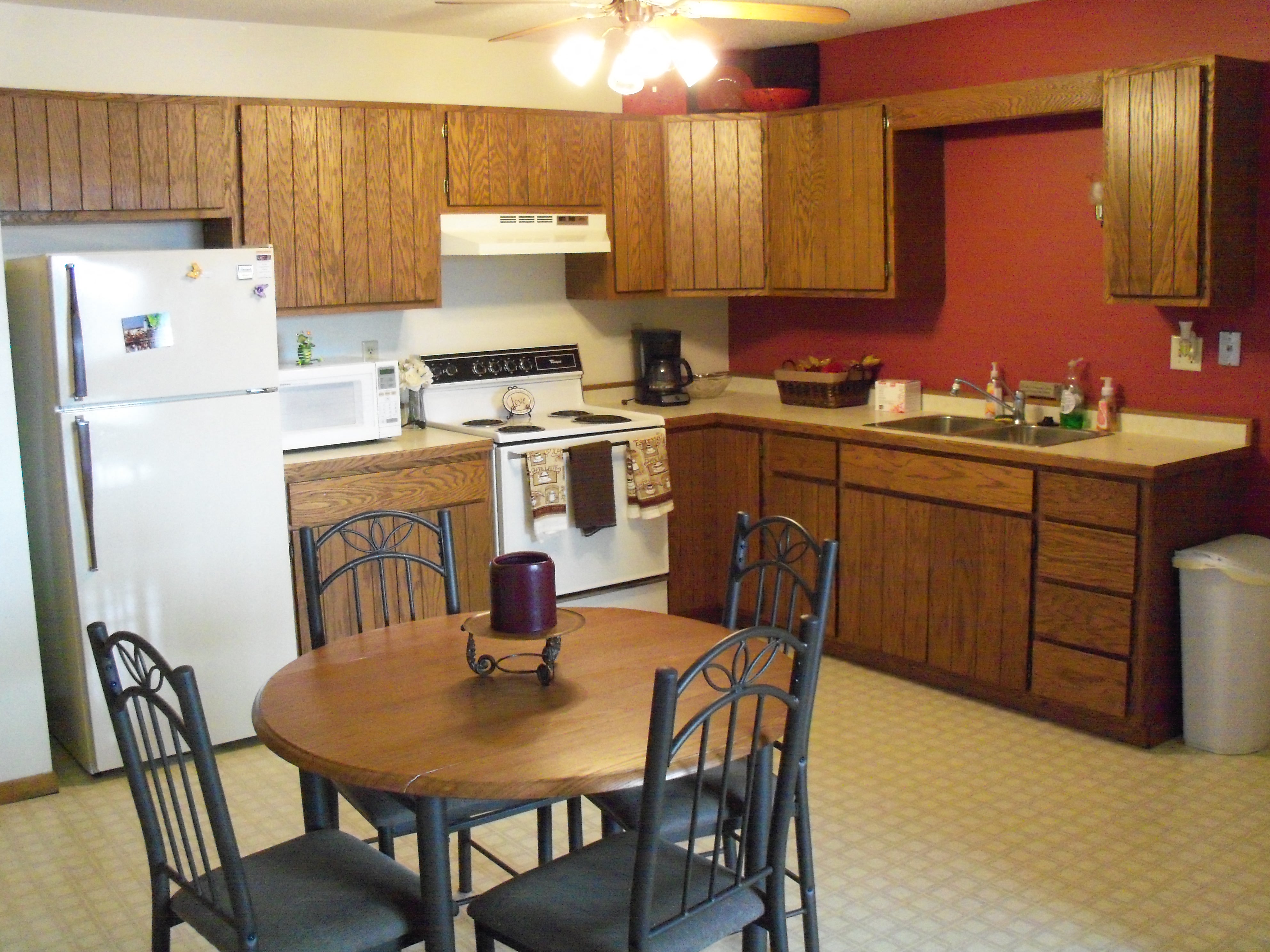 a kitchen and dining area with a table and chairs