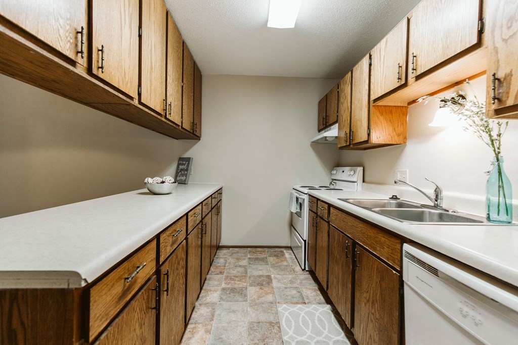 Grand Forks, ND Carling Manor Apartments | Kitchen Grand Forks, ND Carling Manor Apartments. a kitchen with wooden cabinets and a white counter top