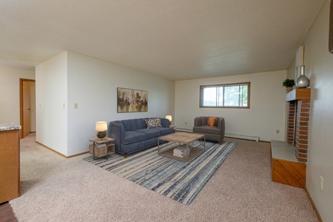 an open living room with couches and a coffee table