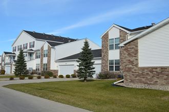 a row of Fargo, ND Charleswood Townhomes on the side of a street