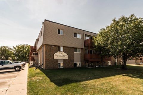 Grand Forks, ND Cherry Creek Apartments. Exterior with trees