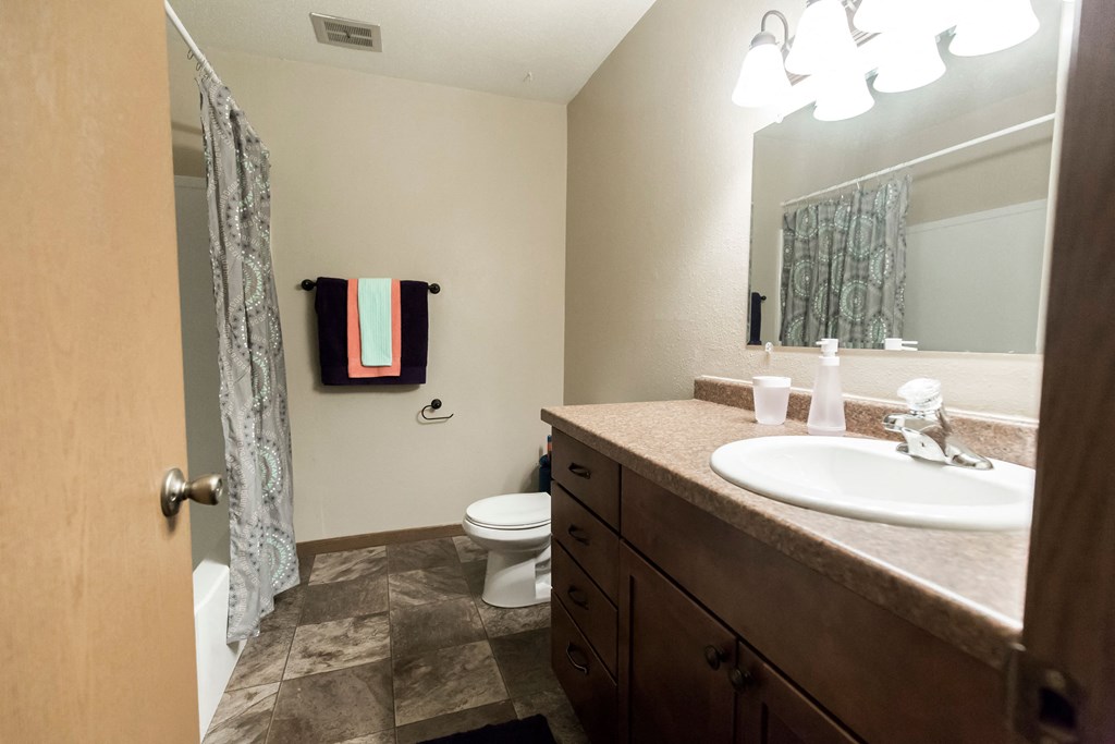 Grand Forks, ND Cherry Creek Apartments. A bathroom with tile flooring and hand towels