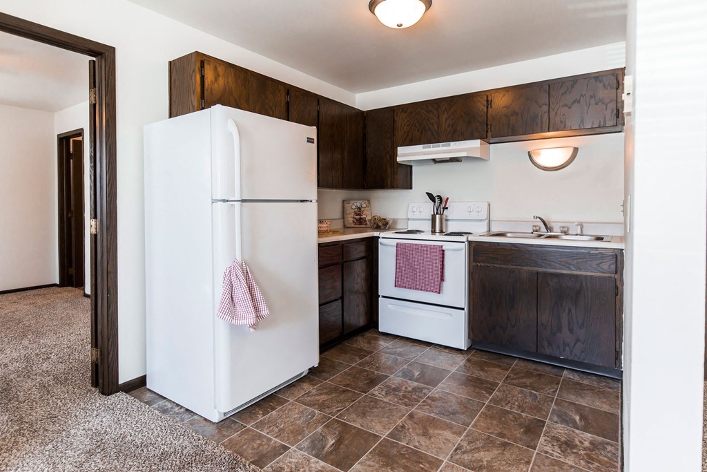 Grand Forks, ND Claremont Apartments. A kitchen with white appliances