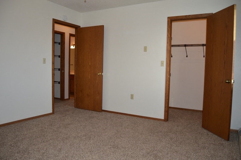 Fargo, ND Clearview Apartments | Bedroom A bedroom with two doors and a closet