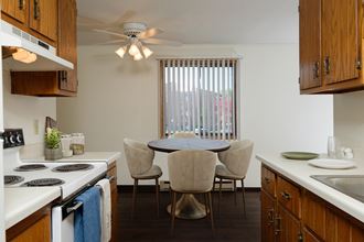 a kitchen and dining room with a table and chairs. Fargo, ND Countryside Apartments