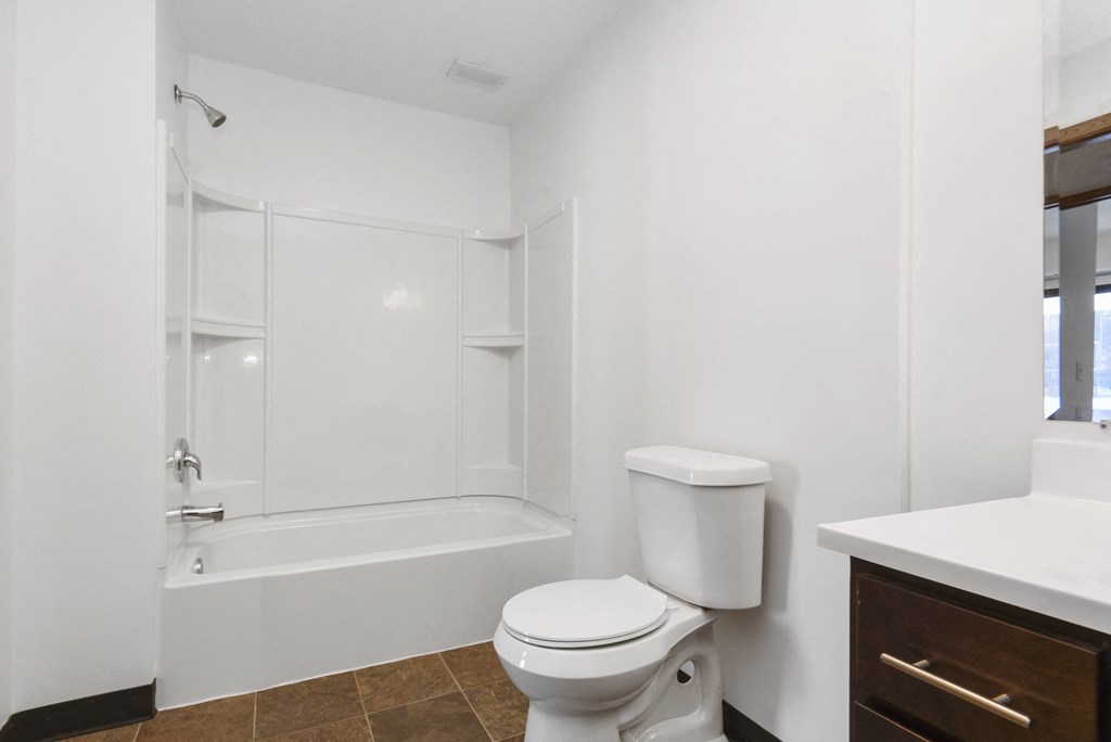 St. Louis Park, MN Courtyard Apartments. A bathroom with a toilet sink and bathtub