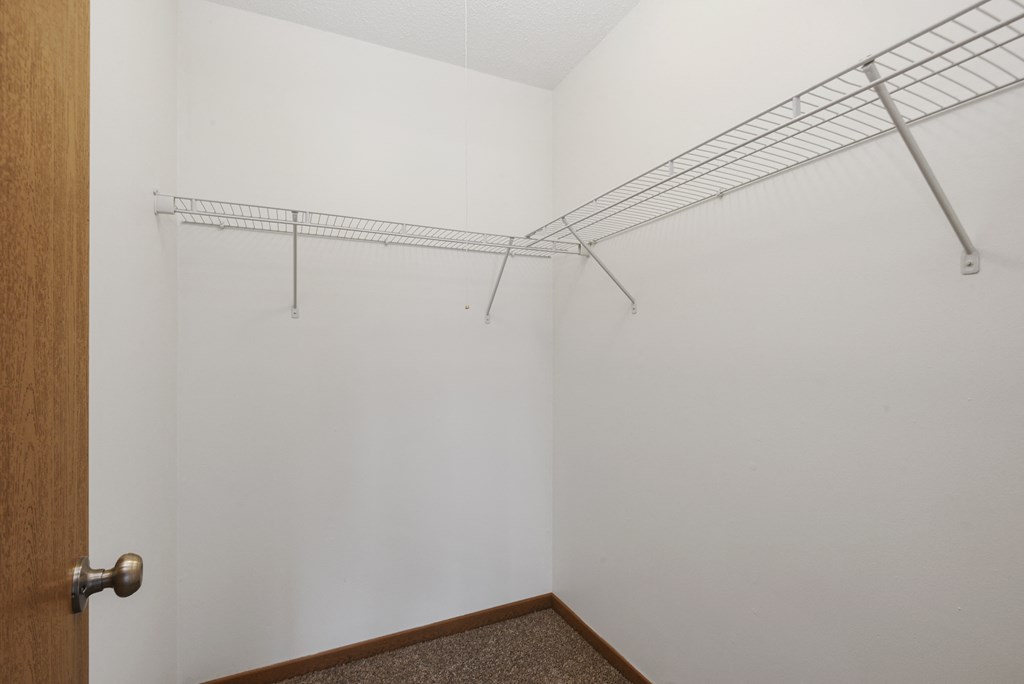 St. Louis Park, MN Courtyard Apartments. A walk in closet with shelves for storage or hanging clothes