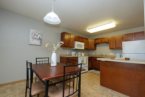 a kitchen and dining room with a table and chairs